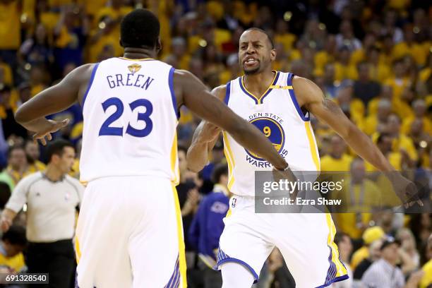 Andre Iguodala and Draymond Green of the Golden State Warriors react to a play against the Cleveland Cavaliers in Game 1 of the 2017 NBA Finals at...