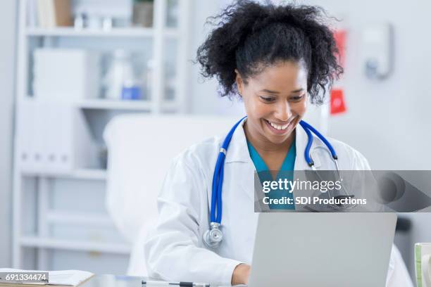 confident female doctor works in her office - doctor laptop stock pictures, royalty-free photos & images