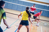 Two couples playing badminton