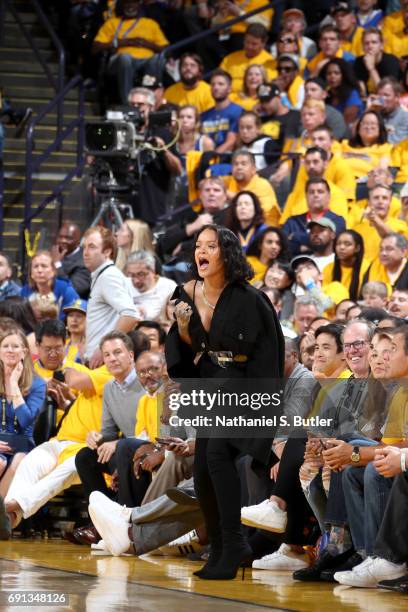 Rihanna cheers from the side line during the game of the Golden State Warriors and the Cleveland Cavaliers in Game One of the 2017 NBA Finals on June...
