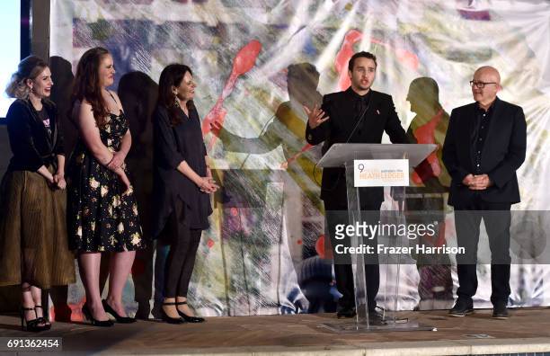 Actor Mojean Aria accepts the 2017 Heath Ledger Scholarship with Kim Ledger, Kate Ledger, Ashleigh Bell and Sally Bell during the 9th Annual...