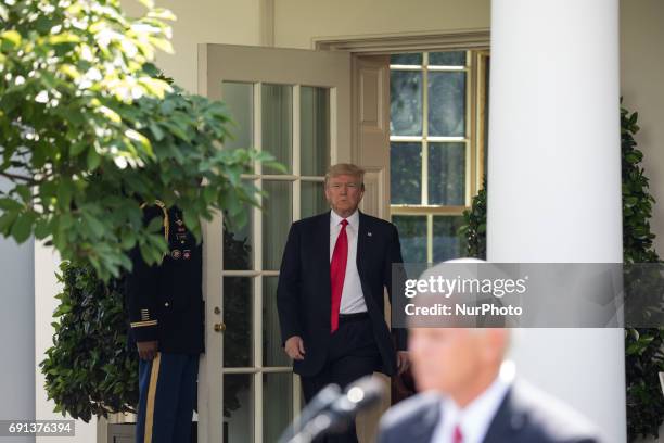 Mike Pence introduces President Donald Trump as he walks out the Oval Office to make his statement that the United States is withdrawing from the...