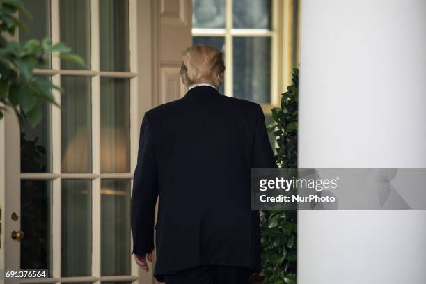President Donald Trump heads back to the Oval Office, after speaking and making the announcement that the United States is withdrawing from the Paris...