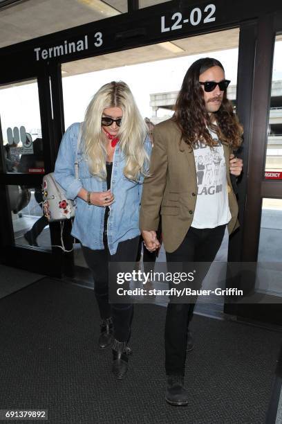 Kesha and Brad Ashenfelter are seen at LAX on June 01, 2017 in Los Angeles, California.