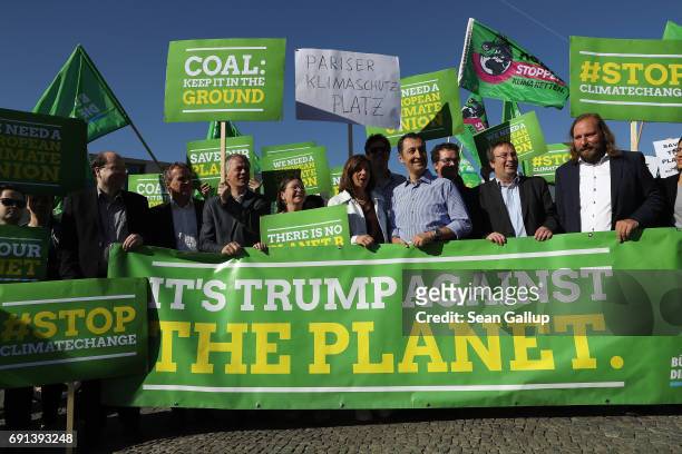 Members of the German Greens Party , including party co-heads Katrin Goering-Eckardt and Cem Oezdemir , protest outside the U.S. Embassy against the...