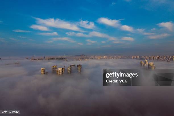 Advection fog surrounds buildings on June 2, 2017 in Rizhao, Shandong Province of China.