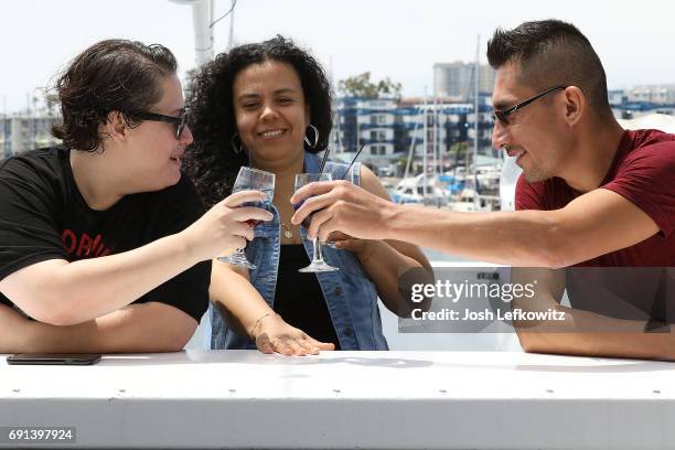 Jasmine Gutierrez, Lorena Montelongo and Emmanuel Lopez are seen toasting to a good time at the DoctorFrank.com Memorial Day Yacht Cruise on May 29,...