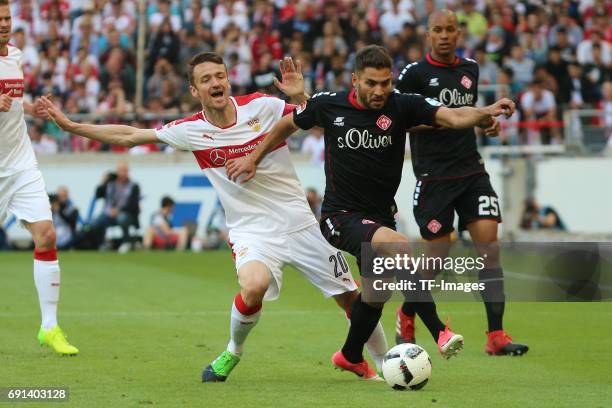 Christian Gentner of Stuttgart and Neijmeddin Daghfous of Wuerzburger Kickers battle for the ball during the Second Bundesliga match between VfB...