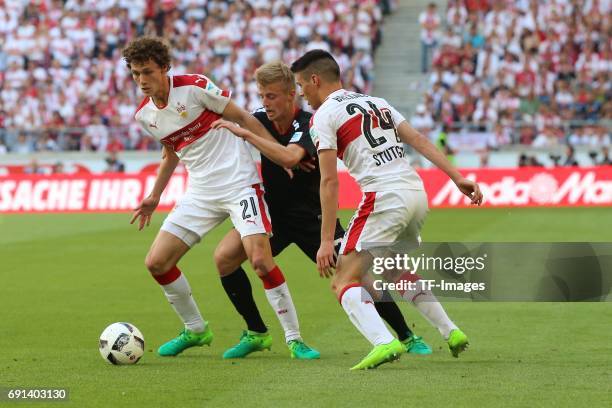 Benjamin Pavard of Stuttgart and Sebastian Ernst of Wuerzburger Kickers and Josip Brekalo of Stuttgart battle for the ball during the Second...