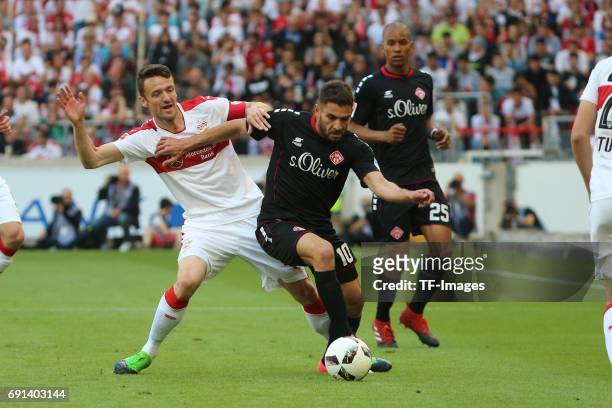 Christian Gentner of Stuttgart and Neijmeddin Daghfous of Wuerzburger Kickers battle for the ball during the Second Bundesliga match between VfB...