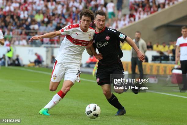 Benjamin Pavard of Stuttgart and Peter Kurzweg of Wuerzburger Kickers battle for the ball during the Second Bundesliga match between VfB Stuttgart...