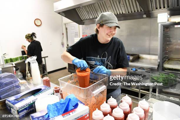 May 08: Pizza Carrello co-owner, Ariane Jimison, center, works in the kitchen on Monday May 08, 2017 in Gillette, WY. The area is a large producer of...
