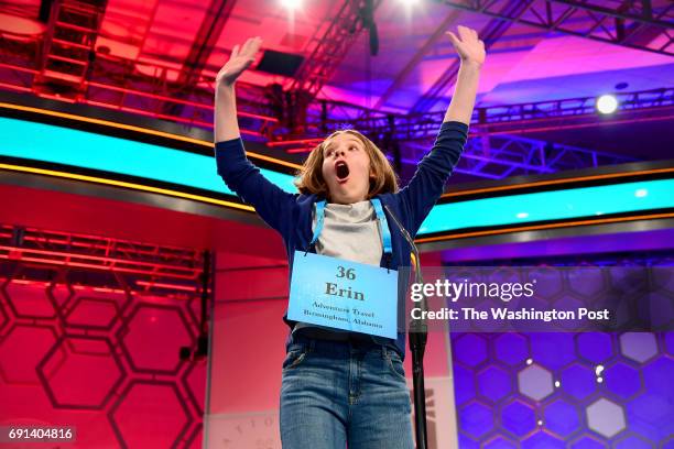 Spelling bee contestant Erin Howard from Huntsville, Ala., reacts as she spells her word correctly during the morning session of the 90th Scripps...