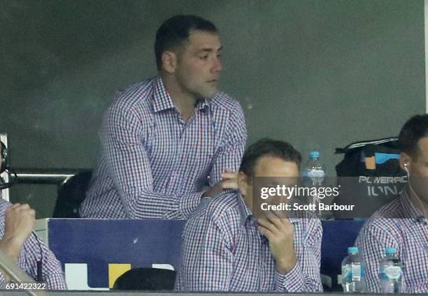 Craig Bellamy, coach of the Storm and Cameron Smith look on from the coaches box during the round 13 NRL match between the Melbourne Storm and the...