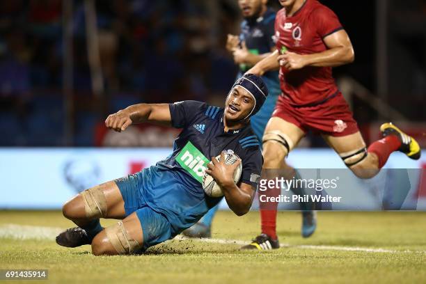 Gerard Cowley-Tuioti of the Blues scores a try during the round 15 Super Rugby match between the Blues and the Reds at Apia Park National Stadium on...