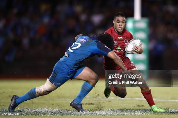 Duncan Paia'aua of the Reds is tackled during the round 15 Super Rugby match between the Blues and the Reds at Apia Park National Stadium on June 2,...