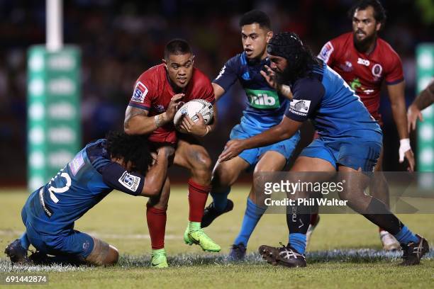 Duncan Paia'aua of the Reds is tackled during the round 15 Super Rugby match between the Blues and the Reds at Apia Park National Stadium on June 2,...