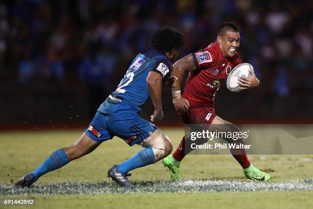 Duncan Paia'aua of the Reds is tackled during the round 15 Super Rugby match between the Blues and the Reds at Apia Park National Stadium on June 2,...