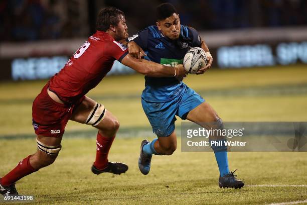 Stephen Perofeta of the Blues is tackled during the round 15 Super Rugby match between the Blues and the Reds at Apia Park National Stadium on June...