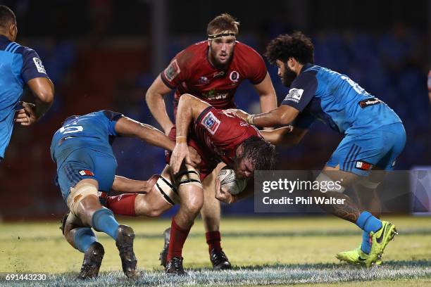 Kane Douglas os the Reds is tackled during the round 15 Super Rugby match between the Blues and the Reds at Apia Park National Stadium on June 2,...