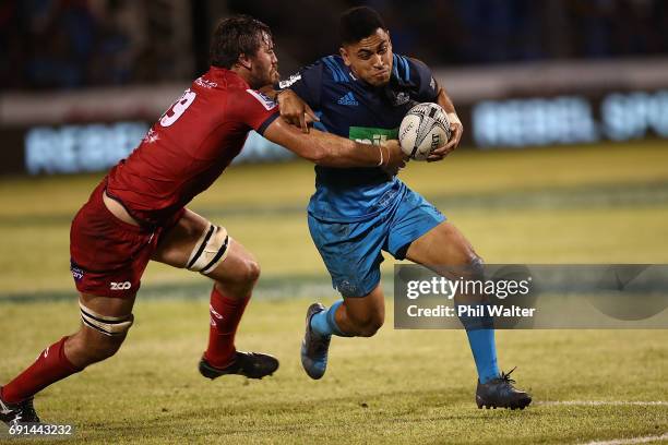 Stephen Perofeta of the Blues is tackled during the round 15 Super Rugby match between the Blues and the Reds at Apia Park National Stadium on June...