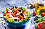 Fresh salad plate on blue picnic table
