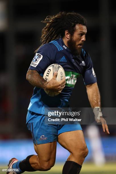 Rene Ranger of the Blues heads in for a try during the round 15 Super Rugby match between the Blues and the Reds at Apia Park National Stadium on...