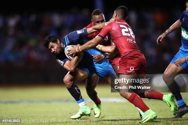 Melani Nanai of the Blues is tackled during the round 15 Super Rugby match between the Blues and the Reds at Apia Park National Stadium on June 2,...