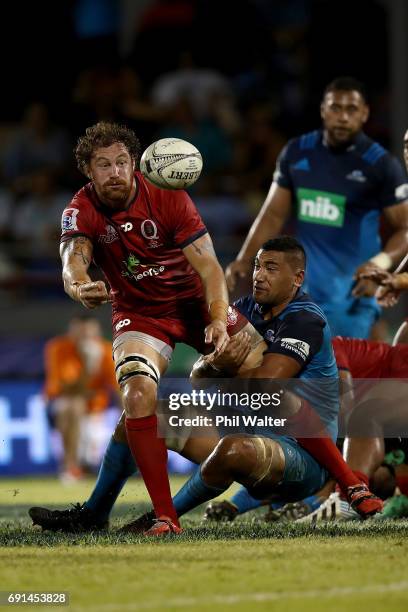 Scott Higginbotham of the Reds passes during the round 15 Super Rugby match between the Blues and the Reds at Apia Park National Stadium on June 2,...