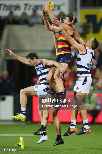 Jake Lever of the Crows marks the ball over Daniel Menzel of the Cats who loses his boot during the round 10 AFL match between the Collingwood...