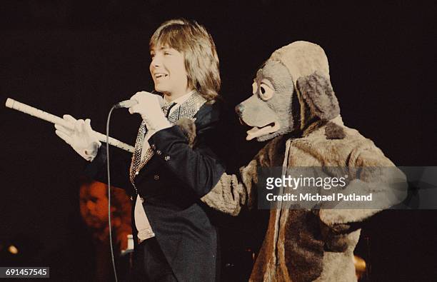 American actor and pop singer David Cassidy and a person in a dog costume, performing on a European tour, 1974.