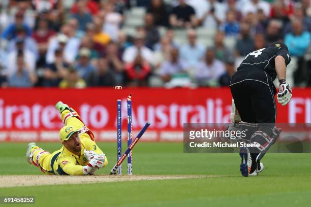 Matthew Wade the wicketkeeper of Australia misses an opportunity to run out Luke Ronchi of New Zealand during the ICC Champions Trophy match between...