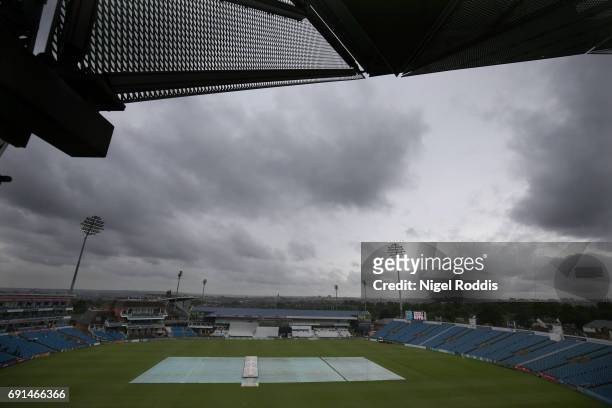 The covers are seen protecting the wicket as rain delays play on Day One of the Specsavers County Championship Division One match between Yorkshire...