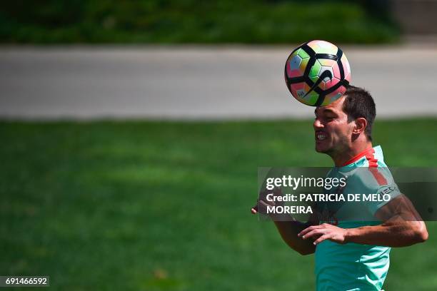 Portugal's midfielder Cedric Soares heads the ball during a training session at "Cidade do Futebol" training camp in Oeiras, outskirts of Lisbon, on...