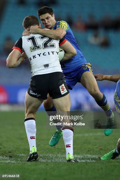 Ryan Hoffman of the Warriors is tackled by Mitch Moses of the Eels during the round 13 NRL match between the Parramatta Eels and the New Zealand...