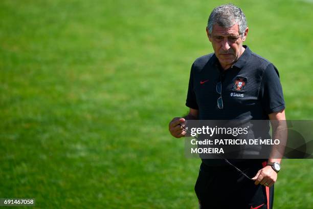 Portugal's head coach Fernando Santos stands on the pitch during a training session at "Cidade do Futebol" training camp in Oeiras, outskirts of...