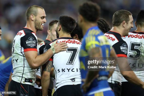 Simon Mannering of the Warriors celebrates with his team mate Shaun Johnson of the Warriors after scoring a try during the round 13 NRL match between...