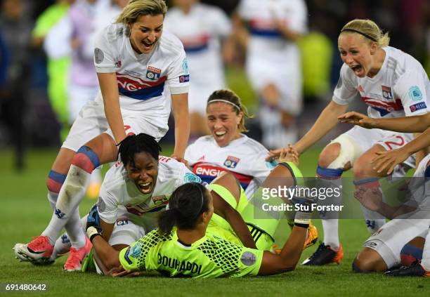 Olympique Lyonnais players race to celebrate with goalkeeper Sarah Bouhaddi who had scored the winning penalty during the UEFA Women's Champions...
