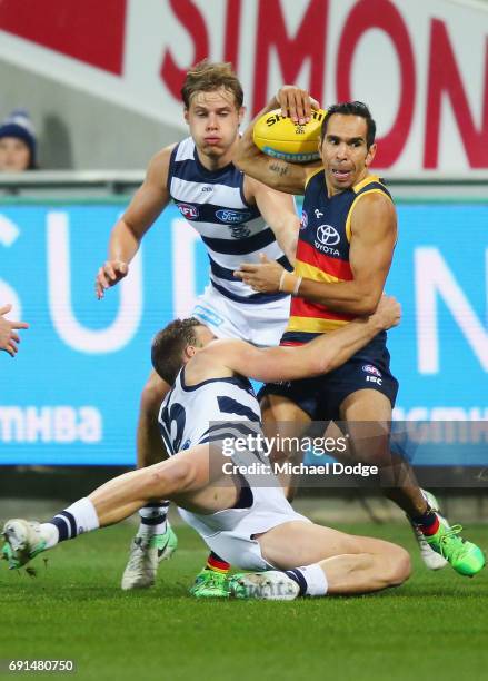 Eddie Betts of the Crows is tackled by Lachie Henderson of the Cats during the round 11 AFL match between the Geelong Cats and the Adelaide Crows at...