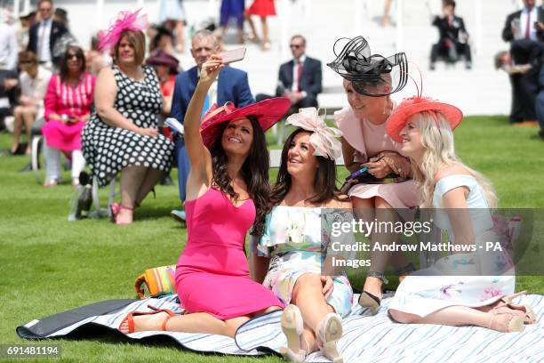 Female racegoers take a selfie on Ladies Day during the 2017 Investec Epsom Derby Festival at Epsom Racecourse, Epsom.