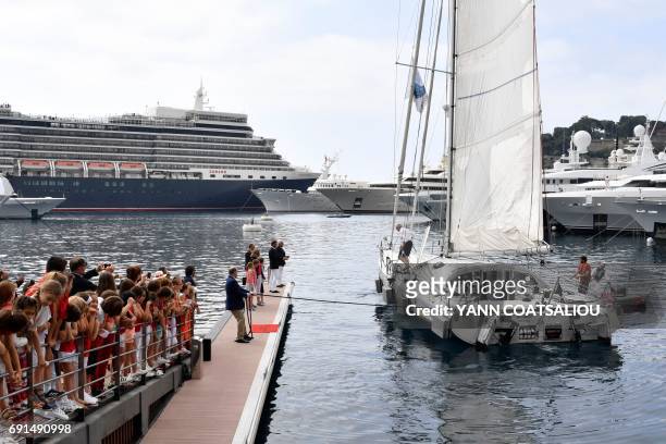 Prince Albert II of Monaco helps to moor the OceanoScientific Explorer sailing boat called "Boogaloo" steered by French sailor Yvan Griboval, at the...