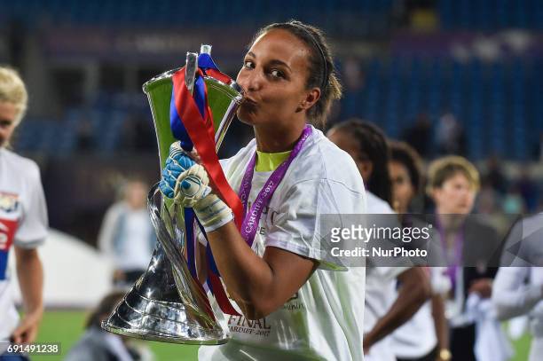 Sarah Bouhaddi of Olympique Lyon kiesses the Champions League trophy during the UEFA Women's Champions League Final between Lyon Women and Paris...