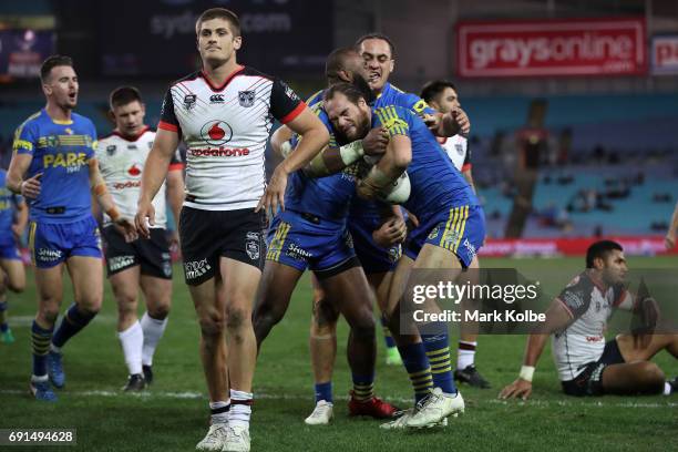 Tepai Moeroa of the Eels celebrates with his team mates after scoring a try during the round 13 NRL match between the Parramatta Eels and the New...