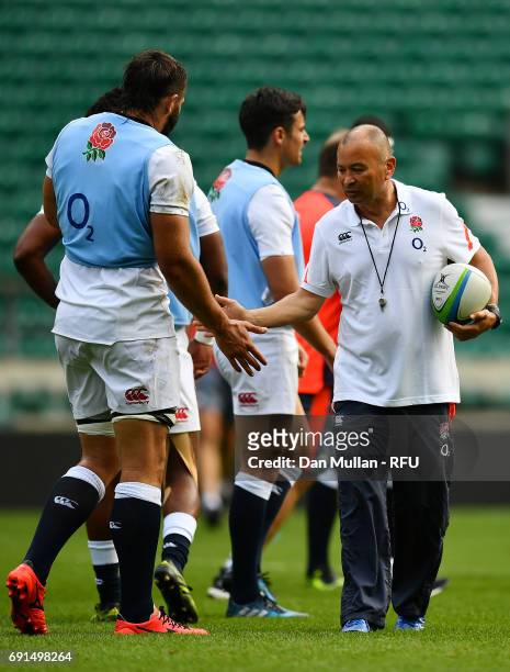 Eddie Jones, Head Coach of England high fives Don Armand of England during a training session at Twickenham Stadium on June 2, 2017 in London,...