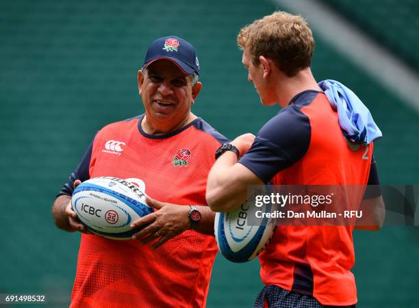 Glen Ella, Skills Coach of England talks with Sam Vesty, Skills Coach of England during a training session at Twickenham Stadium on June 2, 2017 in...