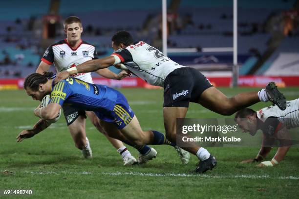 Tepai Moeroa of the Eels of the Eels dives over to score during the round 13 NRL match between the Parramatta Eels and the New Zealand Warriors at...