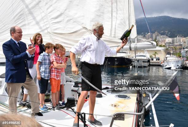 French sailor Yvan Griboval , flanked by Prince Albert II of Monaco, Oceano Scientific Association President Cecile d'Estais-Griboval and the...