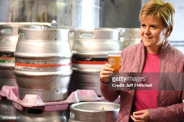 Leader Nicola Sturgeon has a pint of beer as she takes a tour of Kelburn Brewery while campaigning for the General Election on June 2, 2017 in...