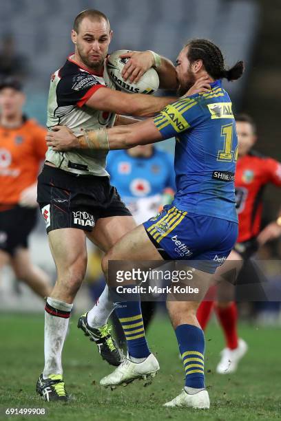 Simon Mannering of the Warriors is tackled by Tepai Moeroa of the Eels during the round 13 NRL match between the Parramatta Eels and the New Zealand...