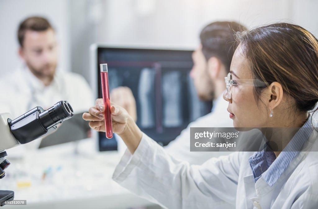 Scientist Looking at Test Tube